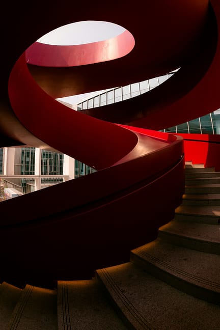 A red, swirling staircase reaches upward.